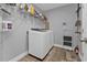 Laundry room with washer, dryer, and ample shelving at 14516 San Domingo Blvd, Port Charlotte, FL 33981