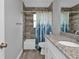 Bathroom with granite countertop, white cabinets, and a shower/tub combo at 14516 San Domingo Blvd, Port Charlotte, FL 33981