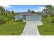 Aerial view showcasing a single-Gathering home with a three-car garage and a spacious lot at 14516 San Domingo Blvd, Port Charlotte, FL 33981