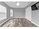 Well-lit bedroom with wood-look floors, double doors, and a mounted TV at 14516 San Domingo Blvd, Port Charlotte, FL 33981