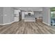 Spacious living area with wood-look floors and access to the backyard at 14516 San Domingo Blvd, Port Charlotte, FL 33981