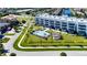 Aerial view of modern condo building with pool and lush landscaping at 1425 Park Beach Cir # 127, Punta Gorda, FL 33950