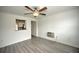 Living room with hardwood floors, kitchen view and A/C unit at 1638 Harmony Dr, Port Charlotte, FL 33952