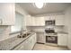 Modern kitchen featuring stainless steel appliances and granite countertops at 1638 Harmony Dr, Port Charlotte, FL 33952