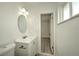 Clean bathroom with white vanity and round mirror at 1638 Harmony Dr, Port Charlotte, FL 33952