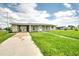Updated one-story home with a carport and front yard at 1638 Harmony Dr, Port Charlotte, FL 33952