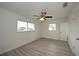 Bright bedroom with ceiling fan and wood-look flooring at 1638 Harmony Dr, Port Charlotte, FL 33952