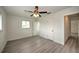 Well-lit bedroom, featuring ceiling fan and wood-look flooring at 1638 Harmony Dr, Port Charlotte, FL 33952