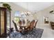 Elegant dining room featuring a rustic wood table and leather chairs at 16407 San Edmundo Rd, Punta Gorda, FL 33955