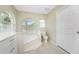 Bathroom with corner soaking tub and large window at 16407 San Edmundo Rd, Punta Gorda, FL 33955