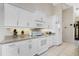 Modern kitchen with white cabinets, granite counters, and stainless steel appliances at 16407 San Edmundo Rd, Punta Gorda, FL 33955