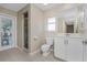 Clean bathroom, white vanity, toilet and walk-in shower at 16407 San Edmundo Rd, Punta Gorda, FL 33955