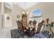 Bright dining room with an oval wood table and leather chairs near large windows at 16407 San Edmundo Rd, Punta Gorda, FL 33955