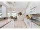 Modern kitchen with white cabinets, granite counters and stainless steel appliances at 16407 San Edmundo Rd, Punta Gorda, FL 33955