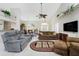Comfortable living room with neutral decor, plush sofas, and a large TV at 16407 San Edmundo Rd, Punta Gorda, FL 33955