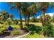 Lush landscaping featuring tropical plants and palm trees at 16407 San Edmundo Rd, Punta Gorda, FL 33955