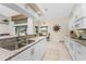 Modern kitchen with white cabinets, granite counters and stainless steel appliances at 16407 San Edmundo Rd, Punta Gorda, FL 33955