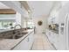 Modern kitchen with white cabinets, granite counters and stainless steel appliances at 16407 San Edmundo Rd, Punta Gorda, FL 33955