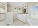 Main bathroom with soaking tub, walk-in shower, and double vanity at 16407 San Edmundo Rd, Punta Gorda, FL 33955