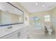 Bathroom with double vanity and large soaking tub at 16407 San Edmundo Rd, Punta Gorda, FL 33955
