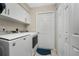 Laundry room with washer, dryer, and ample cabinet space at 16407 San Edmundo Rd, Punta Gorda, FL 33955