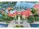Resort-style community pool and clubhouse with palm trees at 89 Vivante Blvd # 305, Punta Gorda, FL 33950