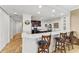 Modern kitchen with dark wood cabinets and a breakfast bar at 89 Vivante Blvd # 305, Punta Gorda, FL 33950