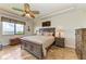 Spacious bedroom with water views, tiled floors, and a ceiling fan at 89 Vivante Blvd # 305, Punta Gorda, FL 33950