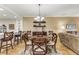 Well-lit dining area with a round table, chairs, and adjacent kitchen counter at 89 Vivante Blvd # 305, Punta Gorda, FL 33950