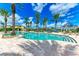 Inviting resort-style pool with palm trees and lounge area at 89 Vivante Blvd # 305, Punta Gorda, FL 33950