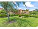 Condo building with manicured landscaping and inviting entrance at 89 Vivante Blvd # 305, Punta Gorda, FL 33950