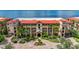 Aerial view of Mediterranean style building, lush landscaping at 89 Vivante Blvd # 305, Punta Gorda, FL 33950