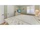 Guest bedroom with coastal decor and en-suite bathroom at 89 Vivante Blvd # 305, Punta Gorda, FL 33950