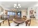 Bright dining room with a round table and chairs, offering views of the living room and balcony at 89 Vivante Blvd # 305, Punta Gorda, FL 33950