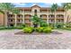 Building exterior showcasing architectural details, landscaping, and a brick paved driveway at 89 Vivante Blvd # 305, Punta Gorda, FL 33950