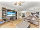 Living area with comfortable seating, a large TV, and views into the dining and kitchen areas at 89 Vivante Blvd # 305, Punta Gorda, FL 33950