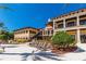 Relaxing pool area with lounge chairs and resort-style building at 89 Vivante Blvd # 305, Punta Gorda, FL 33950