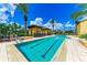 Resort-style pool with lounge chairs and palm trees at 89 Vivante Blvd # 305, Punta Gorda, FL 33950