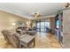 Living room features a large sectional sofa, flat-screen TV, and access to a balcony at 89 Vivante Blvd # 305, Punta Gorda, FL 33950