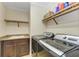 Laundry room with washer, dryer, shelving and granite countertop at 89 Vivante Blvd # 305, Punta Gorda, FL 33950