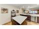 Modern kitchen with island and breakfast bar overlooking living room at 89 Vivante Blvd # 305, Punta Gorda, FL 33950