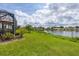 Landscaped backyard with lake view at 1289 Ballota Ln, North Port, FL 34289