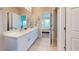 Bathroom featuring double vanity sinks, white cabinets, and tile floors at 25168 E Lenox Cir, Punta Gorda, FL 33950