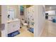 Bright bathroom featuring white cabinets, a white countertop, and a toilet decorated with a blue seashell shower curtain at 25168 E Lenox Cir, Punta Gorda, FL 33950