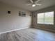 Bright and airy bedroom featuring a ceiling fan and attractive laminate floors at 25168 E Lenox Cir, Punta Gorda, FL 33950