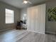 Bedroom with laminate floor, ceiling fan, white wardrobe, and a small window at 25168 E Lenox Cir, Punta Gorda, FL 33950
