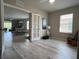 Bright living room with wood floors, open to dining area with neutral color scheme and natural light at 25168 E Lenox Cir, Punta Gorda, FL 33950