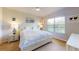 Serene main bedroom features a plush bed, neutral color palette, and a bright window view at 25168 E Lenox Cir, Punta Gorda, FL 33950