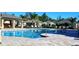 Community pool featuring cool blue water, tile border, adjacent cabana, and lounge seating at 25168 E Lenox Cir, Punta Gorda, FL 33950