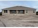Rear view of the home with covered patio and spacious yard, perfect for outdoor living and entertaining at 8347 Ada St, Port Charlotte, FL 33981